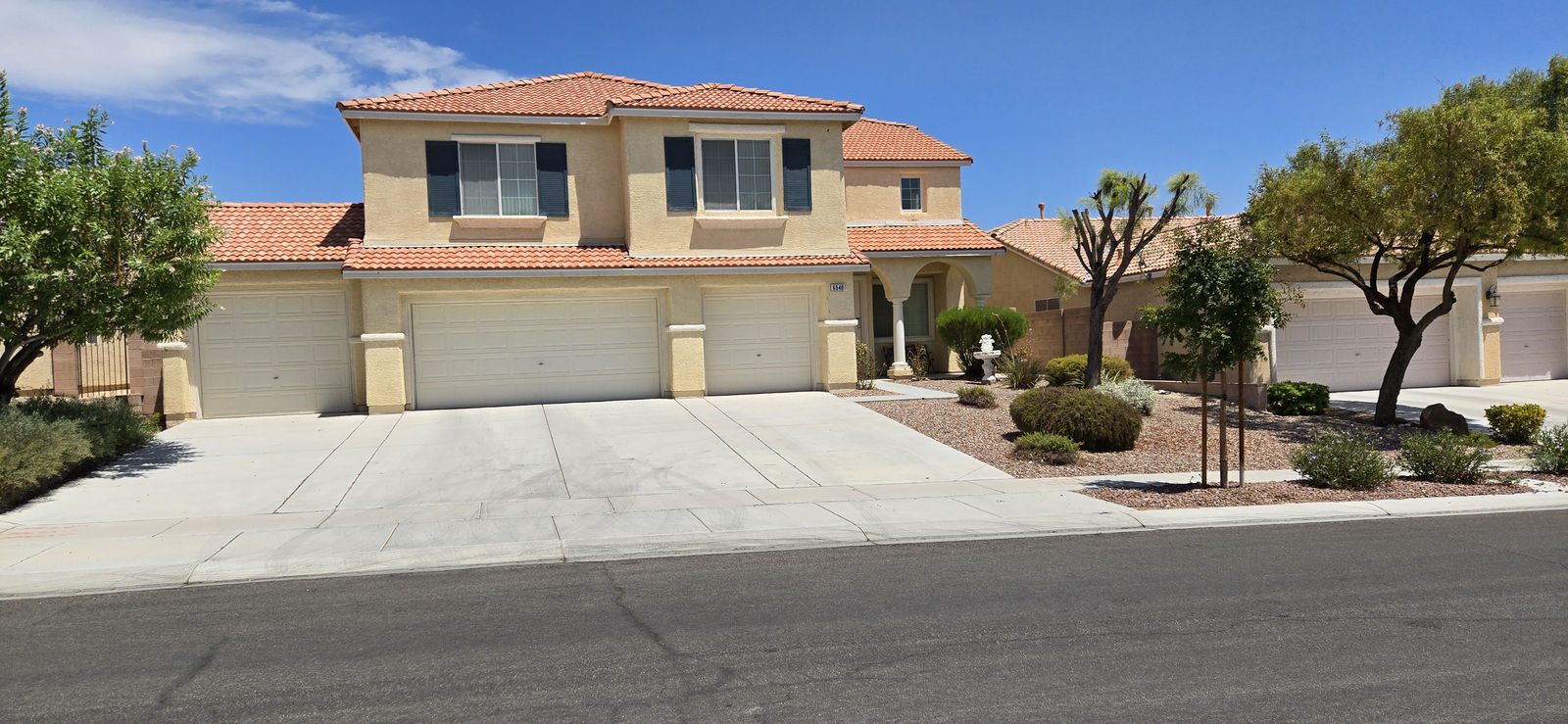 Two-story stucco home in a Las Vegas master-planned community painted in HOA-approved desert colors