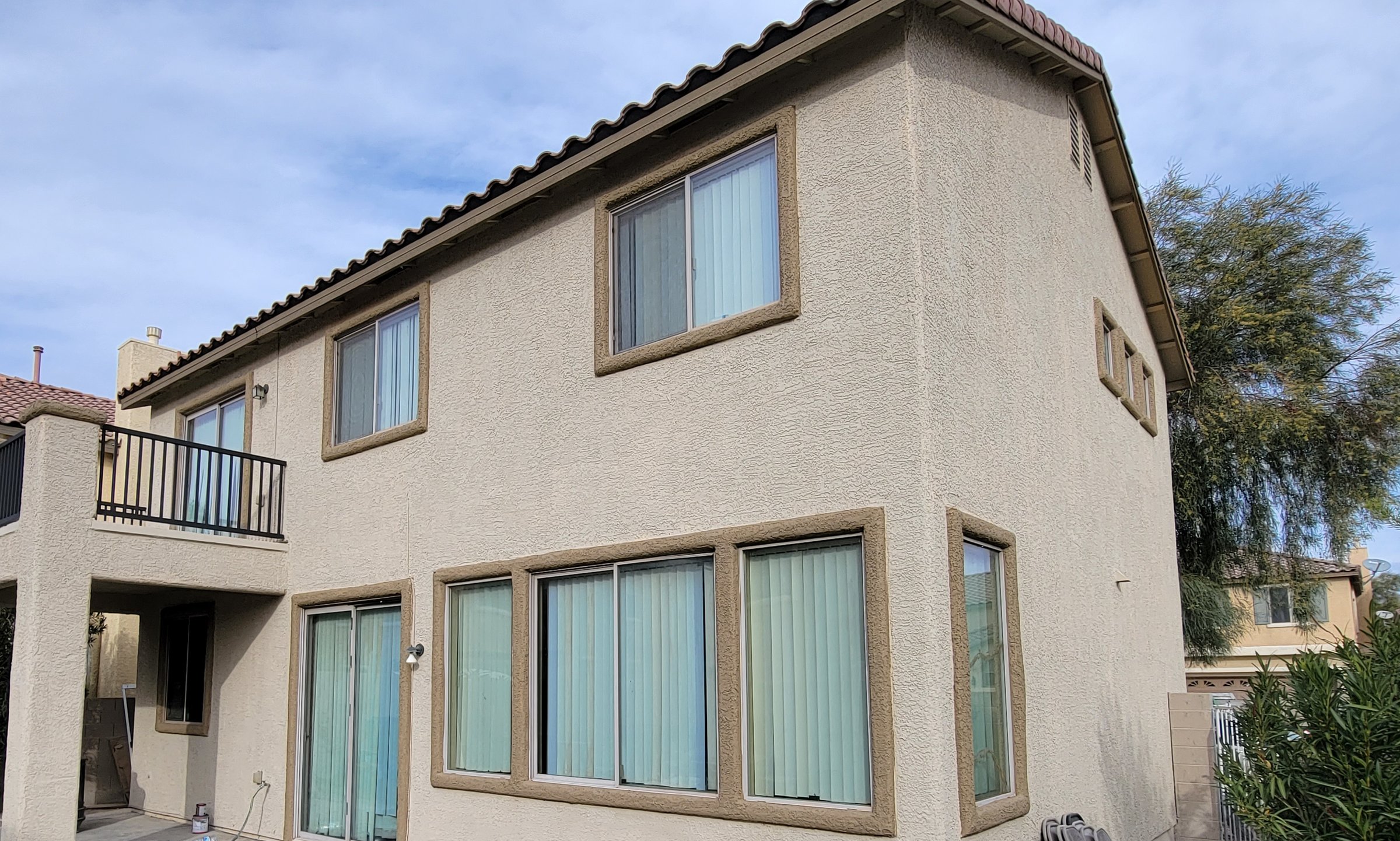 Two-story stucco home exterior repainted by New Visions Painters, serving Desert Shores in northwest Las Vegas