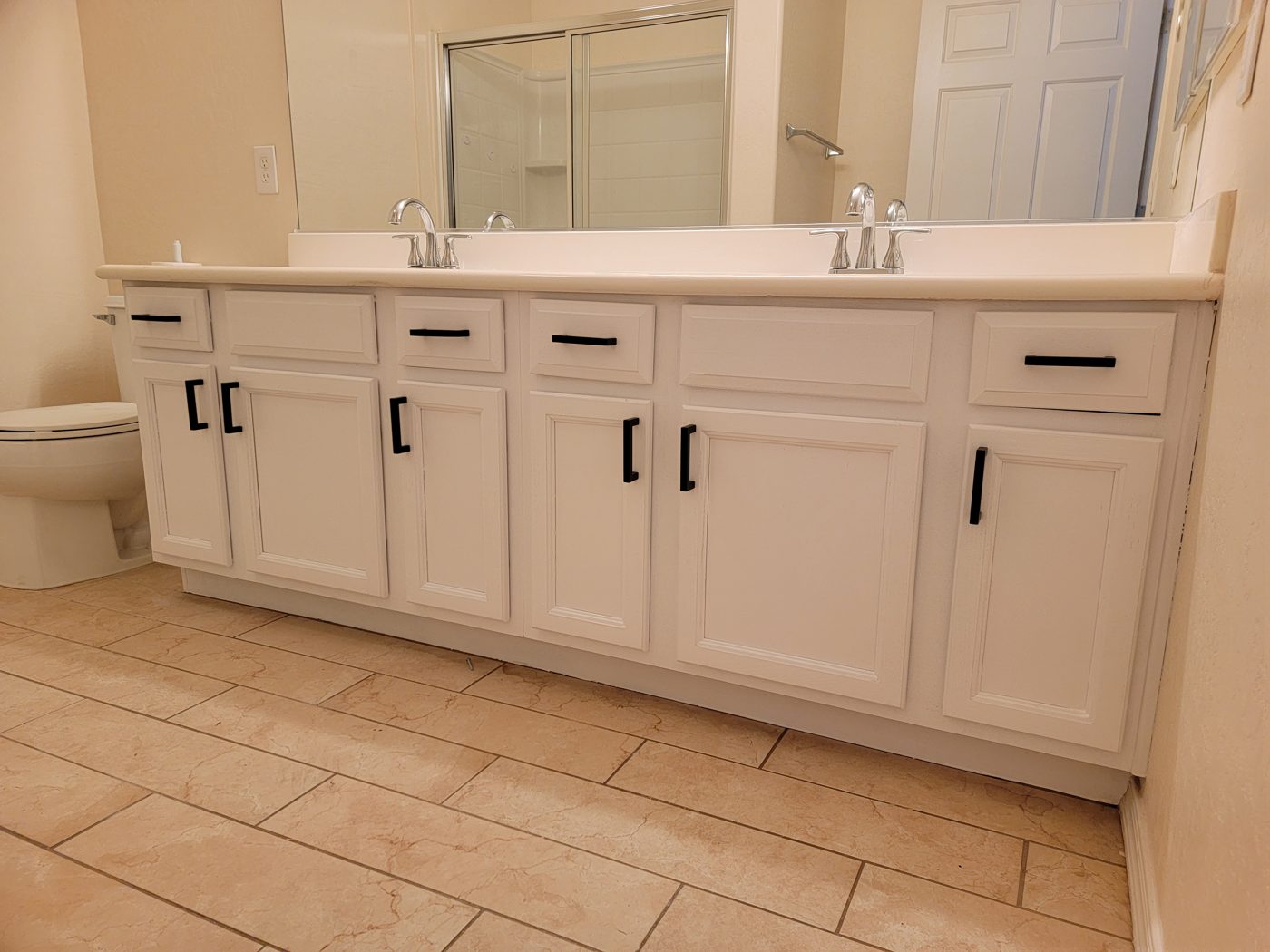 Bathroom vanity cabinets painted white with black hardware in Las Vegas